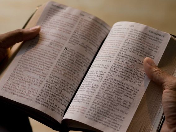 spanish-bible-anniversary-hands-umnews-2019-3500